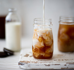 Iced coffee with cream in small bottles