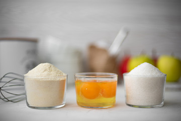 ingredients for apple pie on a white table