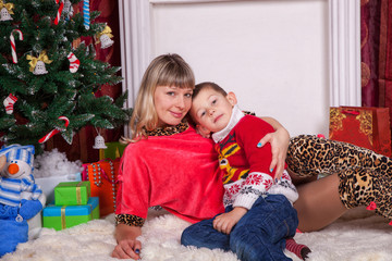 Obraz na płótnie Canvas Happy caucasian family on Christmas eve holiday indoor. Mother and son celebrate Christmas together lifestyle. 