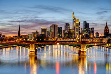 Fototapeta na wymiar Dramatic sunset over downtown Frankfurt and the river Main