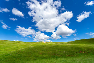 Green hills against the blue sky with clouds. Beautiful screensaver.