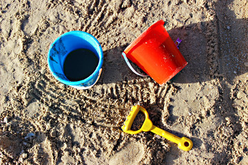 Children's toys for playing in the sandbox and on the beach. Children's buckets and rakes on the...