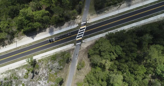 Industrial semi truck driving across crossing on road