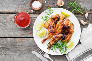 Butterflied grilled whole chicken served with limes and rosemary.