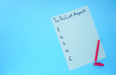 to-do list for August.a pen and a sheet of paper with a to-do list. photo