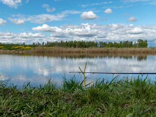 lake landscape with fishing rods in the foreground