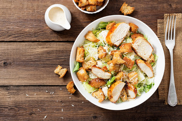 Classic caesar salad with grilled chicken fillet and parmesan cheese. top view