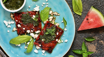 Grilled watermelon with goat cheese and pesto sauce. dish of watermelon.  top view.