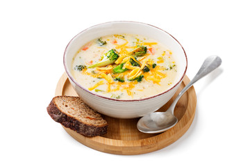 Bowl of creamy broccoli cheddar cheese soup with toasted bread isolated on white background	