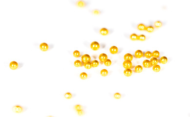 Small balls of gold on a white background.