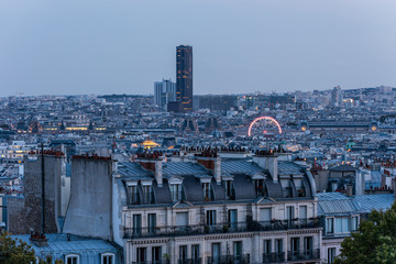 Aerial view of the old town of Paris at night, view from the The Basilica of the Sacred Heart of Paris, at the summit of the butte Montmartre, the highest point in Paris, France