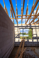 Wooden boards on the roof of the house against the sky.