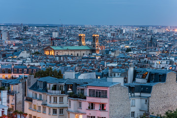Fototapeta na wymiar Aerial view of the old town of Paris at night, view from the The Basilica of the Sacred Heart of Paris, at the summit of the butte Montmartre, the highest point in Paris, France