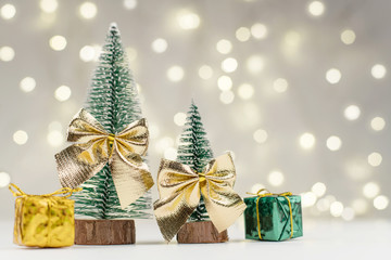 decorative Christmas trees decorated and gifts for the new year on the bokeh background, new year mood 2021