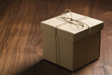 brown paper gift box on walnut table with copy space