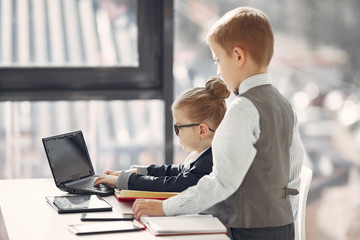 Business theme. Children in a business style. Kid with a laptop.