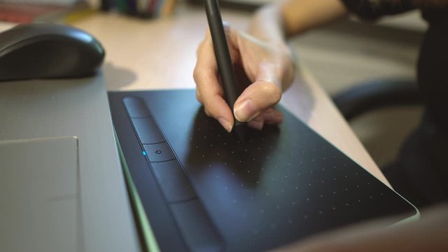 Female graphic designer drawing on digital tablet creating visual art, business woman using computer pad  making web design project  concept, close up view
