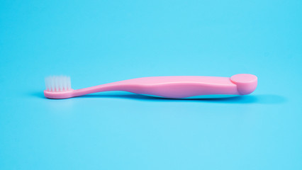 Pink toothbrush isolated on blue background, Blank for design Front view..