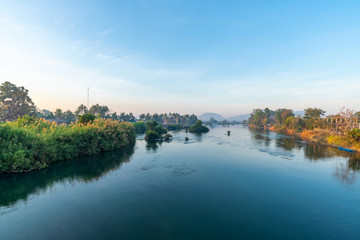 Fototapeta na wymiar Beautiful landscape view of sunrise and old wooden boat drop nearly the river in front of guest house from Don Det the famous place for tourist to relaxing at Siphondon island, Laos.