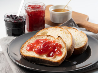 Breakfast image of a jam-smeared loaf of bread