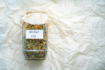 Delicious herbal tea in glass jar. dry useful herb for brewing.