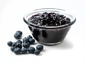 Blueberry jam and blueberry fruit on a white background