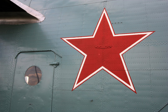 A red soviet star serving as nationality marking at the exterior of a retired super heavy-lift helicopter with green military painting