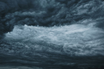 Naklejka na ściany i meble Dark dramatic clouds before a thunderstorm, hurricane, tornado.Abstract sky background.
