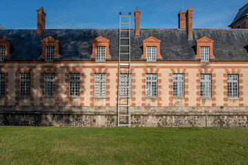Oversized ladder on french country castle aisle