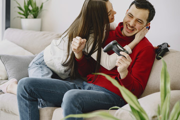 Obraz premium Couple with joysticks. People at home. Pair playing a video games.