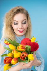 Woman holds tulips and red heart