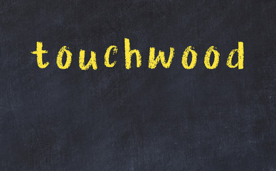 College chalk desk with the word touchwood written on in