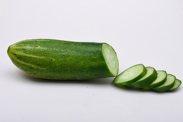 cucumber and cucumber slices on white background
