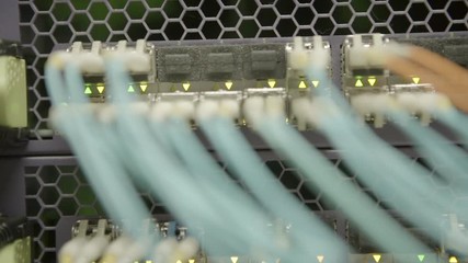 Close-up panning shot of network cables attached to cloud computing system in server room - Silicon Valley, California - Powered by Adobe