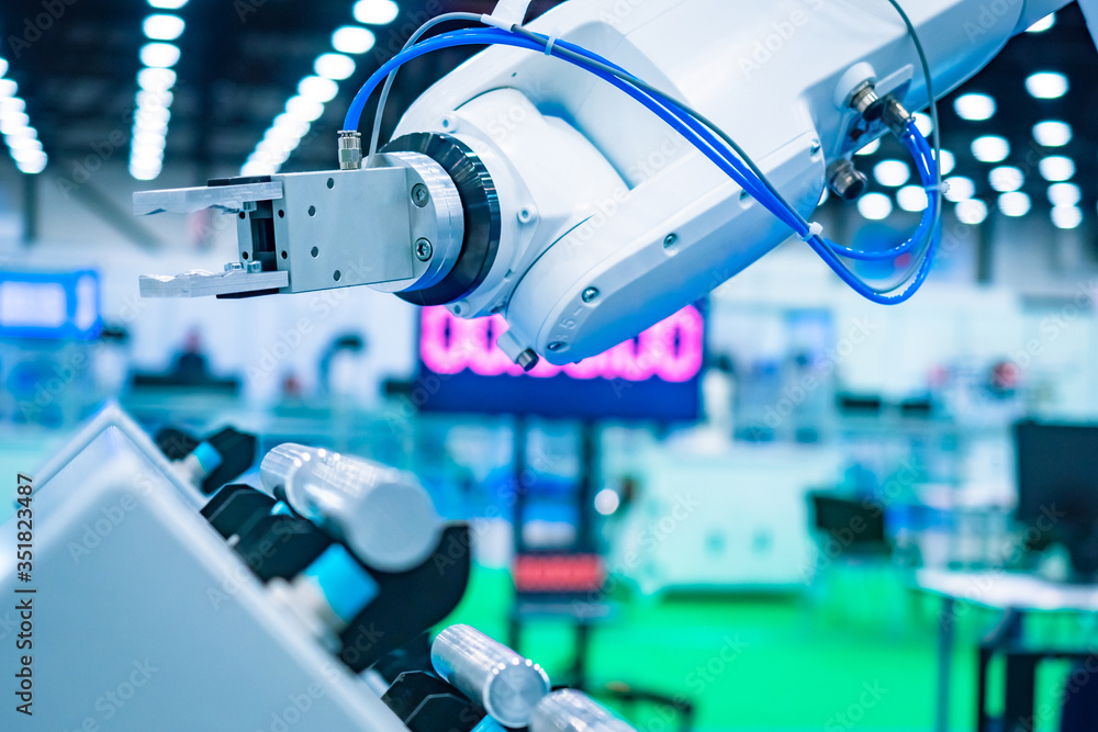 Poster robot assembly on the background of a huge shop. the arm of a robot manipulator. assembly of product