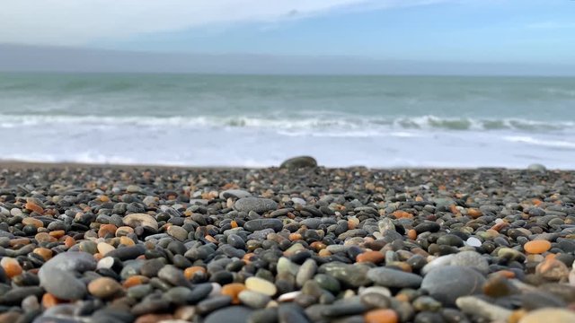 Oamaru beach stony sea, View of rocky beach ocean on sun light in the summer. At Awamoa Beach, Oamaru, New Zealand. 4K UHD, Video Clip with copy or text space.