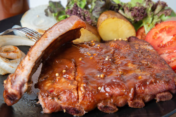 Pork rib grill with barbecue sauce on the plate