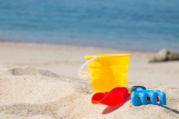 Fototapeta na wymiar bucket, shovel, rake on the beach sand
