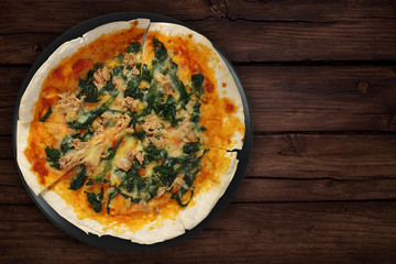 Spinach Tuna Pizza on wood table