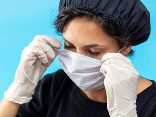 Girl in a medical mask on a blue background