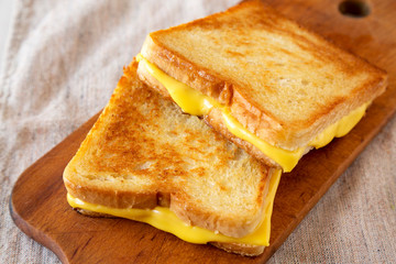 Homemade Grilled Cheese Sandwich on a rustic wooden board , side view. Close-up.
