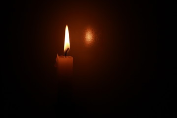 Fototapeta premium burning candle in the dark