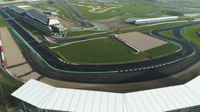 Corners on a race track with single car driving through fast