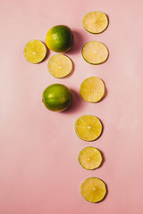 Refreshing citrus, freshly cut lime on a pink background.
