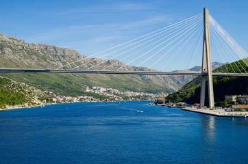 Famous landmark Franjo Tudman Bridge in port of Dubrovnik, Croatia with harbor and panoramic scenic...