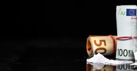 Portion of Cocaine on a dark plate (close-up)
