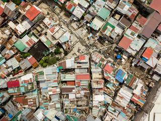 Top view of a impoverished squatter area with narrow passageways and corrugated metal roofs in...