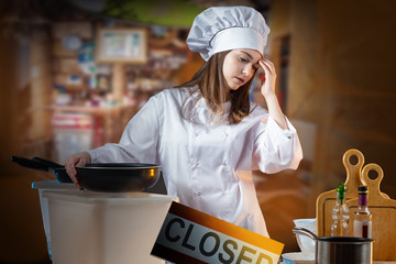 The closing of the restaurant. Girl-chef on the background of th