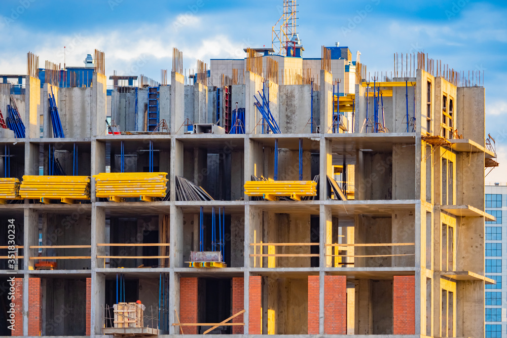 Poster the process of building a multi-storey building. the frame of a building under construction close-up