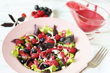 homemade berry vinaigrette. Salad with berries with vinaigrette. Vegetarian salad with raspberries and blueberries.